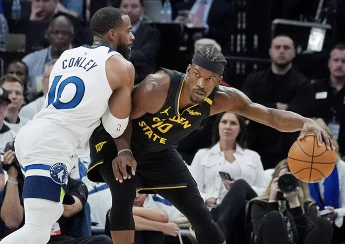 Minnesota Timberwolves guard Mike Conley (10) defends against Golden State Warriors forward Jimmy Butler (10) in the first quarter during game one of the second round for the 2025 NBA Playoffs at Target Center. Mandatory Credit: Bruce Kluckhohn-Imagn Images