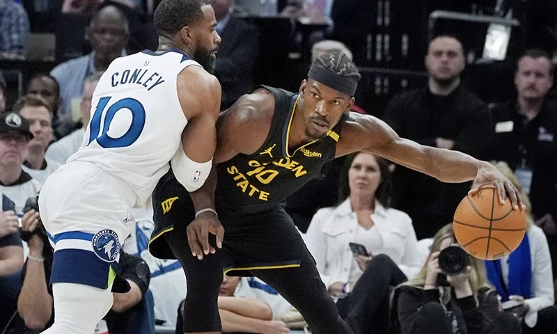 Minnesota Timberwolves guard Mike Conley (10) defends against Golden State Warriors forward Jimmy Butler (10) in the first quarter during game one of the second round for the 2025 NBA Playoffs at Target Center. Mandatory Credit: Bruce Kluckhohn-Imagn Images