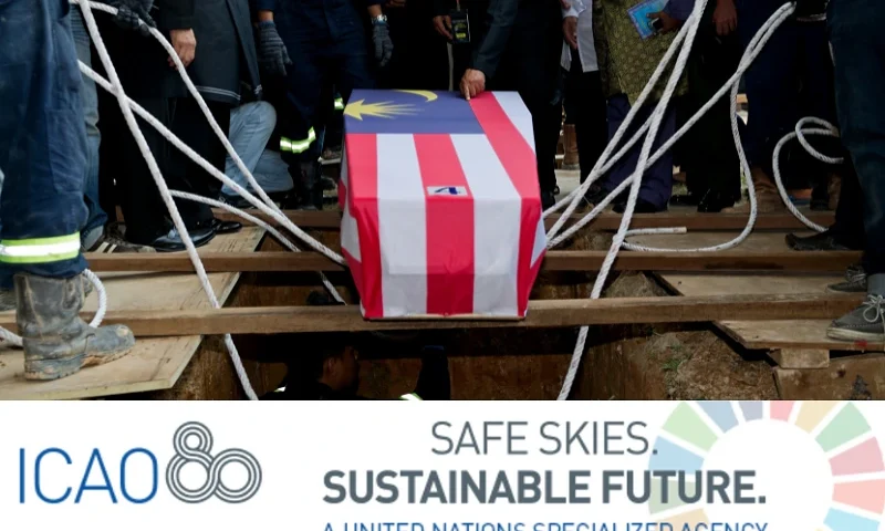 (Background) TOPSHOT - Mohamed Salleh, (C) the father of Malaysia Airlines flight attendant Nur Shazana, one of the Malaysians who perished aboard flight MH17 that was downed in eastern Ukraine, touches her coffin during a burial ceremony in Putrajaya, outside Kuala Lumpur on August 22, 2014. Black-clad Malaysians paused for a minute of silence Friday on a nationwide day of mourning held to sombrely welcome home the first remains of its 43 citizens killed in the MH17 disaster. AFP PHOTO / MOHD RASFAN (Photo by MOHD RASFAN / AFP) (Photo by MOHD RASFAN/AFP via Getty Images) / (Bottom) ICAO Logo. (Photo via: United Nations)