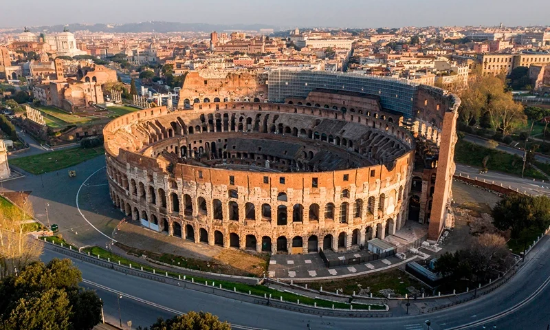 TOPSHOT - A morning aerial photo taken on March 30, 2020 shows deserted streets and the Colosseum monument in Rome during the country's lockdown aimed at curbing the spread of the COVID-19 infection, caused by the novel coronavirus. (Photo by Elio CASTORIA / AFP) / Italy OUT (Photo by ELIO CASTORIA/AFP via Getty Images)