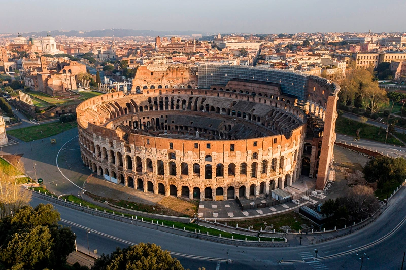 TOPSHOT - A morning aerial photo taken on March 30, 2020 shows deserted streets and the Colosseum monument in Rome during the country's lockdown aimed at curbing the spread of the COVID-19 infection, caused by the novel coronavirus. (Photo by Elio CASTORIA / AFP) / Italy OUT (Photo by ELIO CASTORIA/AFP via Getty Images)
