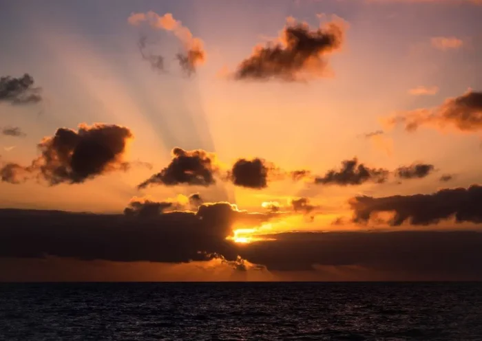 The sun sets, on the way to the Amsterdam Island, part of the five administrative districts of the French Southern and Antarctic Territories, on December 28, 2022. - The research station at Martin-de-Vivies, is the only settlement on the island and is the seasonal home to about thirty researchers and staff studying biology, meteorology, and geomagnetics. The island is home to the endemic Amsterdam albatross. Purest air on earth. Amsterdam is a world benchmark for atmospheric analysis. The site has exceptional qualities: distance of more than 3,000 km from any continent and any human activity. In this area of the southern hemisphere, the air masses are particularly pure and mixed because depressions can easily circumnavigate the island without being stopped. (Photo by Patrick HERTZOG / AFP) (Photo by PATRICK HERTZOG/AFP via Getty Images)