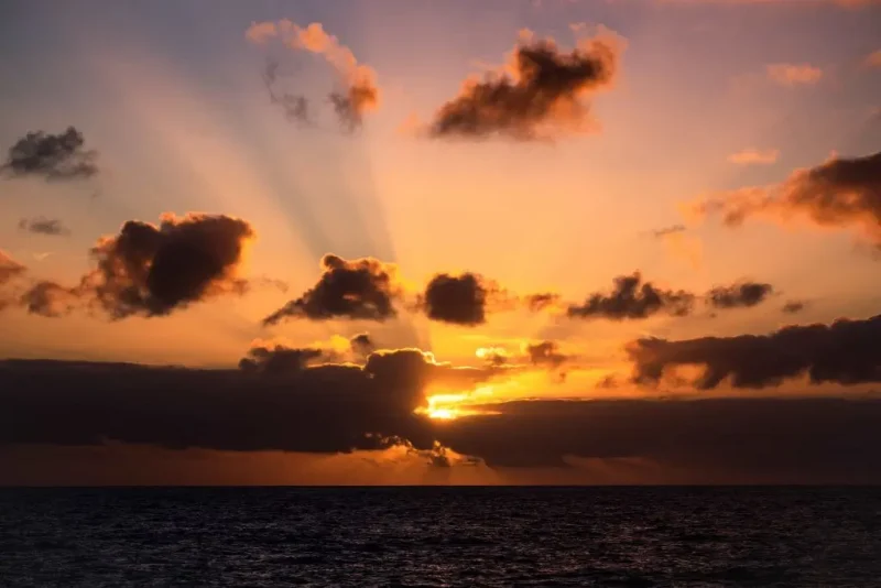 The sun sets, on the way to the Amsterdam Island, part of the five administrative districts of the French Southern and Antarctic Territories, on December 28, 2022. - The research station at Martin-de-Vivies, is the only settlement on the island and is the seasonal home to about thirty researchers and staff studying biology, meteorology, and geomagnetics. The island is home to the endemic Amsterdam albatross. Purest air on earth. Amsterdam is a world benchmark for atmospheric analysis. The site has exceptional qualities: distance of more than 3,000 km from any continent and any human activity. In this area of the southern hemisphere, the air masses are particularly pure and mixed because depressions can easily circumnavigate the island without being stopped. (Photo by Patrick HERTZOG / AFP) (Photo by PATRICK HERTZOG/AFP via Getty Images)