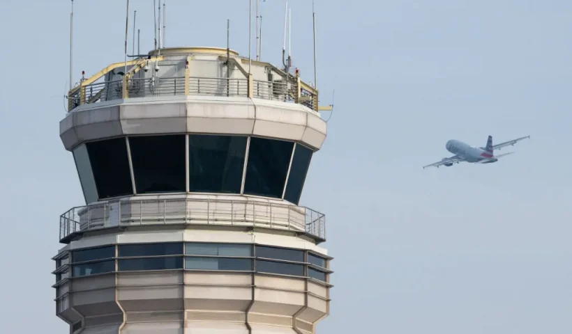 An American Airlines Airbus A319 airplane takes off past the air traffic control tower at Ronald Reagan Washington National Airport in Arlington, Virginia, January 11, 2023. The US Federal Aviation Authority said Wednesday that normal flight operations "are resuming gradually" across the country following an overnight systems outage that grounded departures. (Photo by SAUL LOEB / AFP) (Photo by SAUL LOEB/AFP via Getty Images)