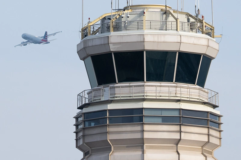 An American Airlines Airbus A319 airplane takes off past the air traffic control tower at Ronald Reagan Washington National Airport in Arlington, Virginia, January 11, 2023. The US Federal Aviation Authority said Wednesday that normal flight operations "are resuming gradually" across the country following an overnight systems outage that grounded departures. (Photo by SAUL LOEB / AFP) (Photo by SAUL LOEB/AFP via Getty Images)