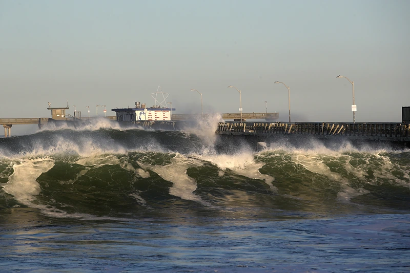 SAN DIEGO, CALIFORNIA - JANUARY 11: Large waves hit the Ocean Beach Pier causing minor damage as high surf advisories were in effect along San Diego beaches on January 11, 2021 in San Diego, California. The high surf advisories remain in effect until mid-day January 12, 2021. (Photo by Sean M. Haffey/Getty Images)