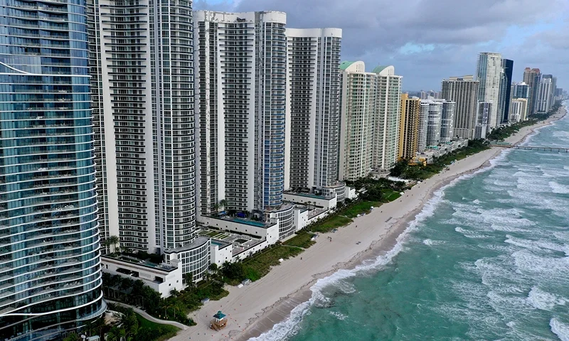 In an aerial view, a strip of beach separates the ocean from condo buildings on February 16, 2022 in Sunny Isles Beach, Florida. A new report released by climate scientists shows that sea levels along coastlines in the United States will rise about one foot by 2050, with larger increases on the East and Gulf coasts. (Photo by Joe Raedle/Getty Images)