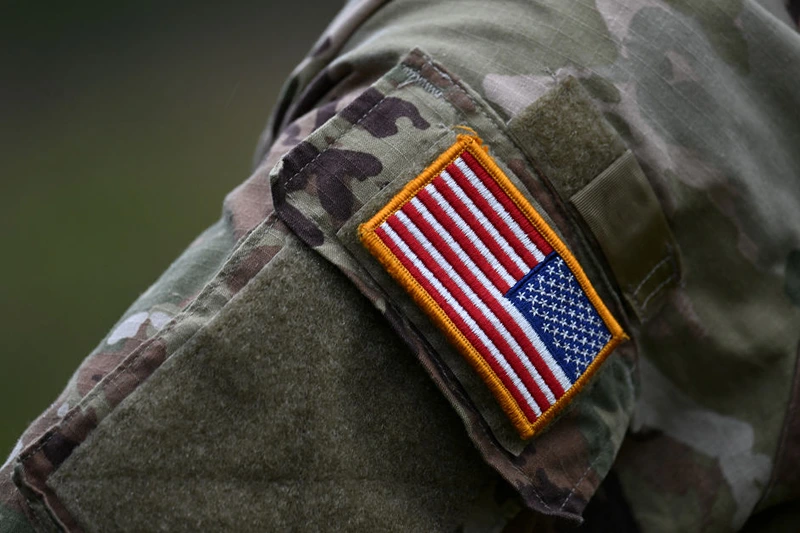 A soldier of the US army wears the country's flag on his uniform during the US army Europe and Africa-directed exercise Combined Resolve 19 at the Hohenfels trainings area, southern Germany, on October 24, 2023. Combined Resolve is a recurring exercise designed to prepare a US brigade combat team in support of NATO deterrence initiatives while also developing and enhancing NATO and key partners interoperability and readiness across specified warfighting functions. (Photo by Christof STACHE / AFP) (Photo by CHRISTOF STACHE/AFP via Getty Images)