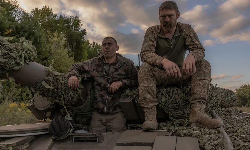 TOPSHOT - Ukrainian tank crew take a break while operating a Soviet-made T-72 tank in the Sumy region, near the border with Russia, on August 12, 2024, amid the Russian invasion of Ukraine. Ukraine launched a surprise offensive into the Russian border region of Kursk on August 6, 2024, capturing over two dozen towns and villages in the most significant cross-border attack on Russian soil since World War II. Ukraine's military chief Oleksandr Syrsky told President Volodymyr Zelensky in a video posted on August 12, 2024 that his troops now control about 1,000 square kilometres of Russian territory and are continuing "offensive operations". (Photo by Roman PILIPEY / AFP) (Photo by ROMAN PILIPEY/AFP via Getty Images)