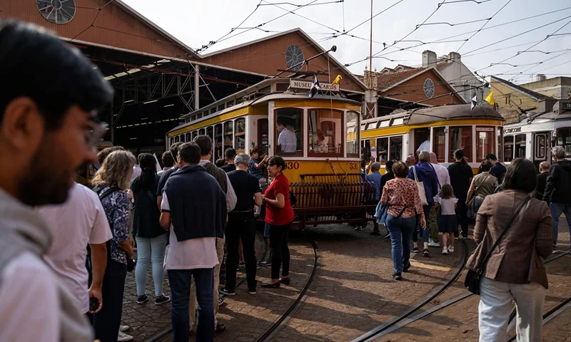 Tourists wait to board in the historical trams of Carris (Lisbon's public transport) during the annual parade of classical trams and buses in celebration of the 152nd anniversary of the company, in Lisbon on September 21, 2024. The iconic Lisbon's yellow trams turned into a touristic attraction at the expense of locals who can no longer find their place. (Photo by Patricia DE MELO MOREIRA / AFP) (Photo by PATRICIA DE MELO MOREIRA/AFP via Getty Images)