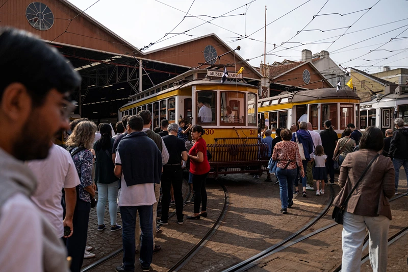 Tourists wait to board in the historical trams of Carris (Lisbon's public transport) during the annual parade of classical trams and buses in celebration of the 152nd anniversary of the company, in Lisbon on September 21, 2024. The iconic Lisbon's yellow trams turned into a touristic attraction at the expense of locals who can no longer find their place. (Photo by Patricia DE MELO MOREIRA / AFP) (Photo by PATRICIA DE MELO MOREIRA/AFP via Getty Images)