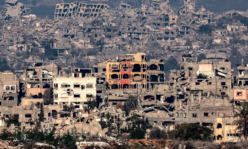 TOPSHOT - This picture taken from the Israeli side of the border with the Gaza Strip shows destroyed buildings in the northern Gaza Strip on January 13, 2025 amid the ongoing war between Israel and Hamas. (Photo by Menahem KAHANA / AFP) (Photo by MENAHEM KAHANA/AFP via Getty Images)