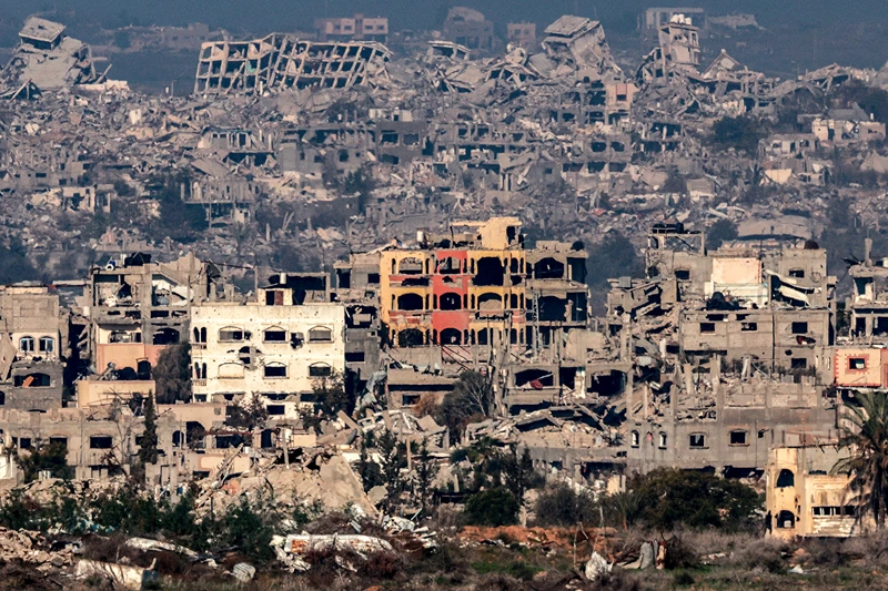 TOPSHOT - This picture taken from the Israeli side of the border with the Gaza Strip shows destroyed buildings in the northern Gaza Strip on January 13, 2025 amid the ongoing war between Israel and Hamas. (Photo by Menahem KAHANA / AFP) (Photo by MENAHEM KAHANA/AFP via Getty Images)