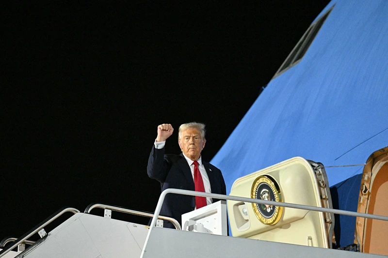 TOPSHOT - US President Donald Trump boards Air Force One at Naval Air Station Joint Reserve Base New Orleans in Louisiana on February 9, 2025, as he returns to Washington, DC, after attending Super Bowl LIX. (Photo by ROBERTO SCHMIDT / AFP) (Photo by ROBERTO SCHMIDT/AFP via Getty Images)