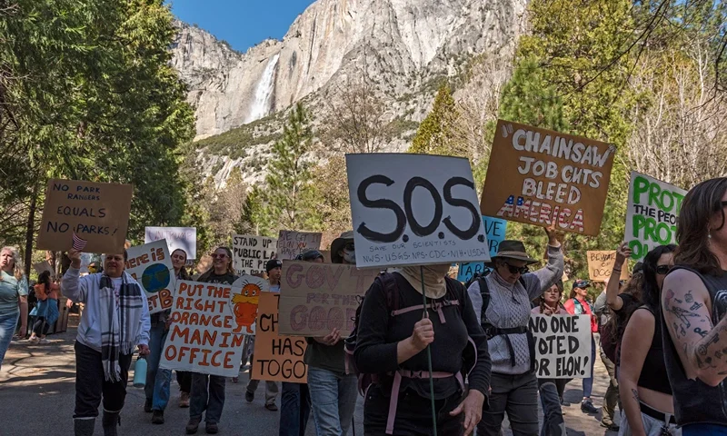 People demonstrate during a protest against federal employee layoffs at Yosemite National Park, California on March 1, 2025. The National Parks Conservation Association (NPCA) estimates 1,000 US National Park Service employees who were on one-year probationary periods were laid off. About 3,400 employees of the US Forest Service were among the cuts too, according to multiple US media reports. The cuts were part of the work of the newly-created Department of Government Efficiency (DOGE), led by billionaire Elon Musk, as part of a declared effort to reduce public spending by dismantling the federal bureaucracy. (Photo by Laure Andrillon / AFP) (Photo by LAURE ANDRILLON/AFP via Getty Images)