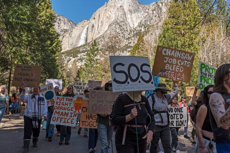 People demonstrate during a protest against federal employee layoffs at Yosemite National Park, California on March 1, 2025. The National Parks Conservation Association (NPCA) estimates 1,000 US National Park Service employees who were on one-year probationary periods were laid off. About 3,400 employees of the US Forest Service were among the cuts too, according to multiple US media reports. The cuts were part of the work of the newly-created Department of Government Efficiency (DOGE), led by billionaire Elon Musk, as part of a declared effort to reduce public spending by dismantling the federal bureaucracy. (Photo by Laure Andrillon / AFP) (Photo by LAURE ANDRILLON/AFP via Getty Images)