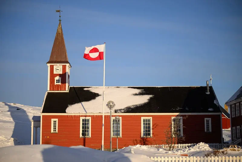 NUUK, GREENLAND - MARCH 30: The flag of Greenland, known locally as "Erfalasorput" flies next to the Church of Our Saviour on March 30, 2025 in Nuuk, Greenland. A visit this week to Greenland by a US delegation - including Vice President JD Vance, his wife and other officials - has provoked angry reactions from politicians here and in Denmark, which governs the foreign and defense policies of the semiautonomous island. The American delegation's visit follows vows by US President Donald Trump to gain control of Greenland "one way or the other," citing its strategic importance to the US. (Photo by Leon Neal/Getty Images)