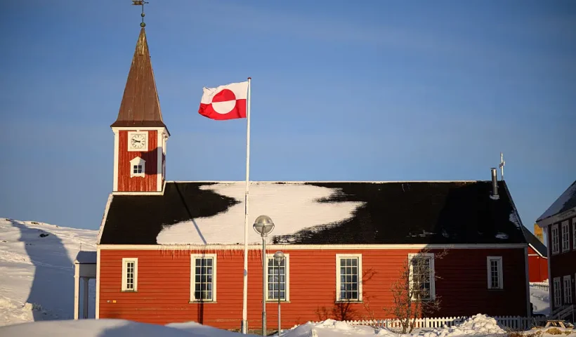 NUUK, GREENLAND - MARCH 30: The flag of Greenland, known locally as "Erfalasorput" flies next to the Church of Our Saviour on March 30, 2025 in Nuuk, Greenland. A visit this week to Greenland by a US delegation - including Vice President JD Vance, his wife and other officials - has provoked angry reactions from politicians here and in Denmark, which governs the foreign and defense policies of the semiautonomous island. The American delegation's visit follows vows by US President Donald Trump to gain control of Greenland "one way or the other," citing its strategic importance to the US. (Photo by Leon Neal/Getty Images)