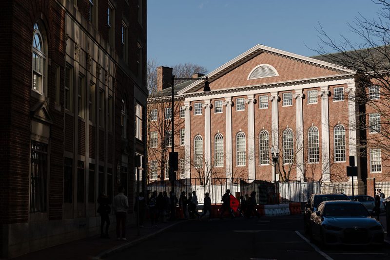 CAMBRIDGE, MASSACHUSETTS - APRIL 17: People walk past Harvard University in Harvard Square on April 17, 2025 in Cambridge, Massachusetts. The Trump administration announced that it would block Harvard University from receiving $2.2 billion in federal grants and $60 million in contracts after the school refused demands to adopt new policies relating to student and faculty conduct, admissions, anti-semitism on campus and DEI. (Photo by Sophie Park/Getty Images)