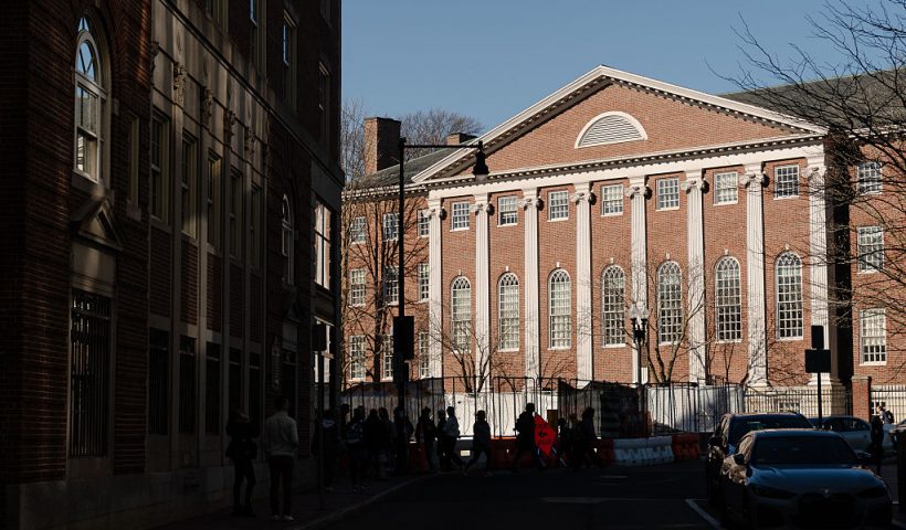 CAMBRIDGE, MASSACHUSETTS - APRIL 17: People walk past Harvard University in Harvard Square on April 17, 2025 in Cambridge, Massachusetts. The Trump administration announced that it would block Harvard University from receiving $2.2 billion in federal grants and $60 million in contracts after the school refused demands to adopt new policies relating to student and faculty conduct, admissions, anti-semitism on campus and DEI. (Photo by Sophie Park/Getty Images)