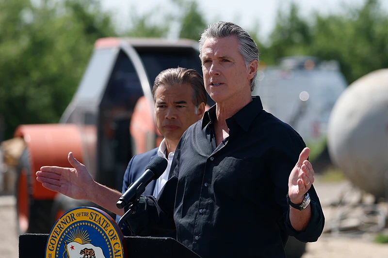 California Governor Gavin Newsom (R) speaks as California Attorney general Rob Bonta looks on during a news conference at Gemperle Orchard. (Photo by Justin Sullivan/Getty Images)