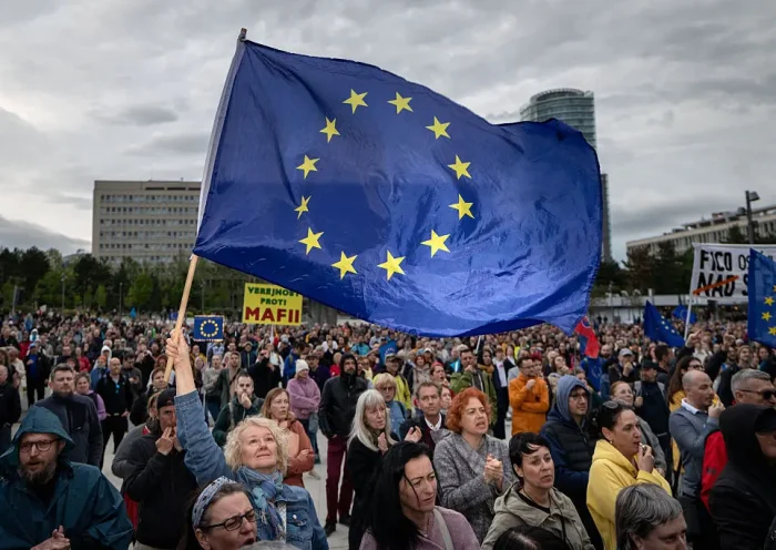 A woman holds an EU flag as people take part in an anti-government protest organized by political activists of the Peace in Ukraine organization under the slogan "No to the Russian Law", against a planned law intended to complicate the work of non-governmental organizations on April 24, 2025, in Bratislava, Slovakia. (Photo by TOMAS BENEDIKOVIC / AFP) (Photo by TOMAS BENEDIKOVIC/AFP via Getty Images)