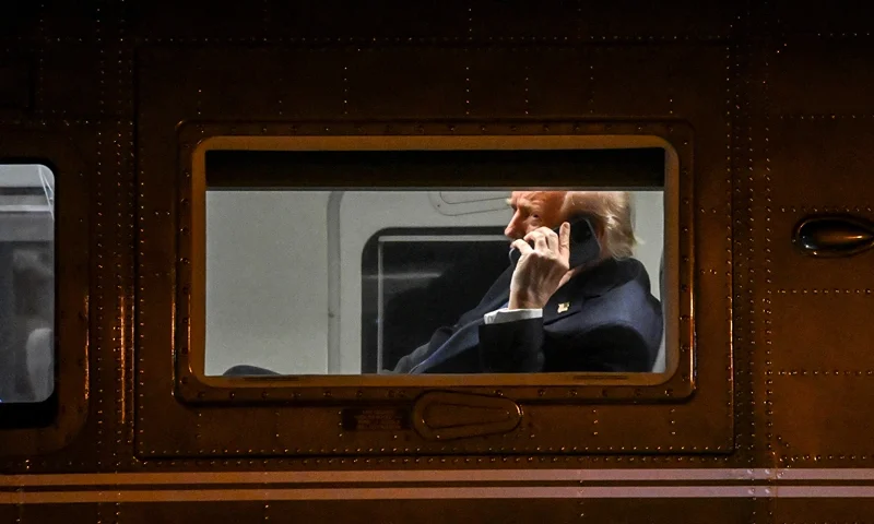 US President Donald Trump uses a cellphone aboard Marine One before it departs Leesburg Executive Airport in Leesburg, Virginia, on April 24, 2025. Trump is returning to the White House after attending a MAGA, Inc. dinner at the Trump National Golf Club Washington, DC. (Photo by Alex WROBLEWSKI / AFP) (Photo by ALEX WROBLEWSKI/AFP via Getty Images)