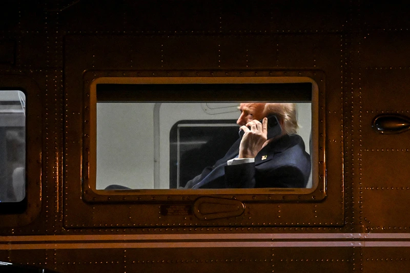 US President Donald Trump uses a cellphone aboard Marine One before it departs Leesburg Executive Airport in Leesburg, Virginia, on April 24, 2025. Trump is returning to the White House after attending a MAGA, Inc. dinner at the Trump National Golf Club Washington, DC. (Photo by Alex WROBLEWSKI / AFP) (Photo by ALEX WROBLEWSKI/AFP via Getty Images)