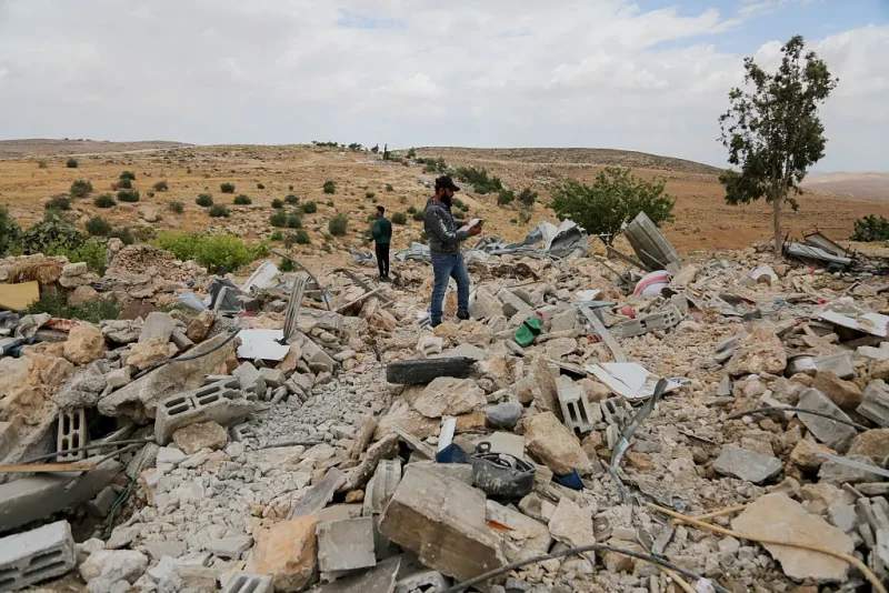 Palestinians investigate the area after armed Israeli army personnel, accompanied by bulldozers destroyed Palestinian structures in Hebron, West Bank, on May 5, 2025. According to reports, Israel destoryed 150 Palestinian buildings and structures in West Bank in April only. (Photo by Mosab shawer / Middle East Images / Middle East Images via AFP) (Photo by MOSAB SHAWER/Middle East Images/AFP via Getty Images)