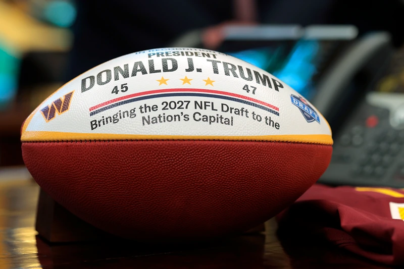 A football honoring the 2027 NFL Draft is seen as U.S. President Donald Trump speaks on the draft in the Oval Office of the White House on May 05, 2025 in Washington, DC. President Trump announced that the 2027 NFL Draft will be held on the National Mall. (Photo by Anna Moneymaker/Getty Images)