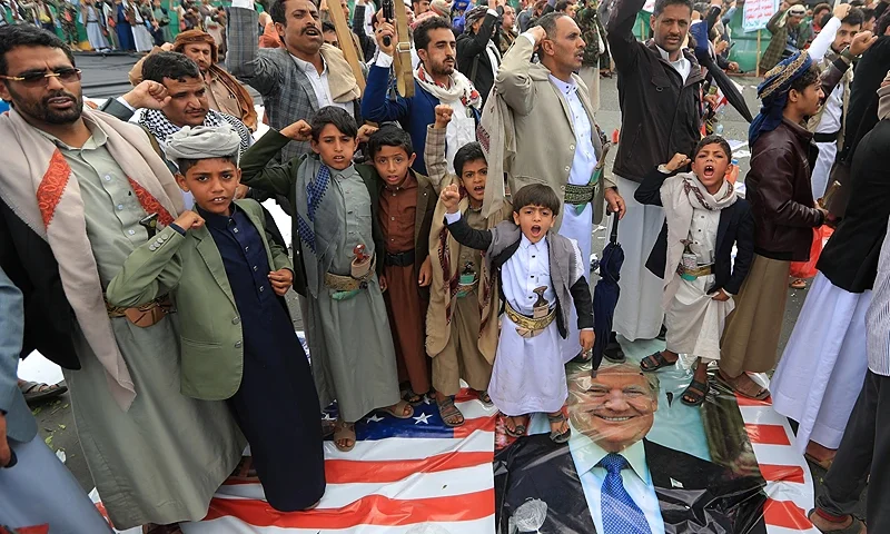 Yemenis step on a portrait of US President Donald Trump during a rally in solidarity with Palestinians in the Gaza Strip, in the Huthi-controlled capital Sanaa on May 9, 2025. Yemen's Huthi rebels said they attacked Israel's main airport on May 9, after the Israeli military said it had intercepted a missile fired from Yemen. (Photo by Mohammed HUWAIS / AFP) (Photo by MOHAMMED HUWAIS/AFP via Getty Images)