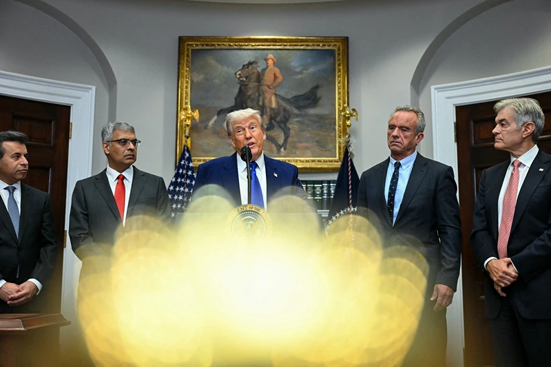 US President Donald Trump (C), alongside (L-R) FDA Commissioner Marty Makary, National Institute of Health (NIH) Director Jayanta Bhattacharya, Secretary of Health and Human Services Robert F. Kennedy Jr and Administrator for the Centers for Medicare and Medicaid Services Mehmet Oz, speaks during a news conference about prescription drug prices, in the Roosevelt Room of the White House on May 12, 2025, in Washington, DC. (Photo by Jim WATSON / AFP) (Photo by JIM WATSON/AFP via Getty Images)