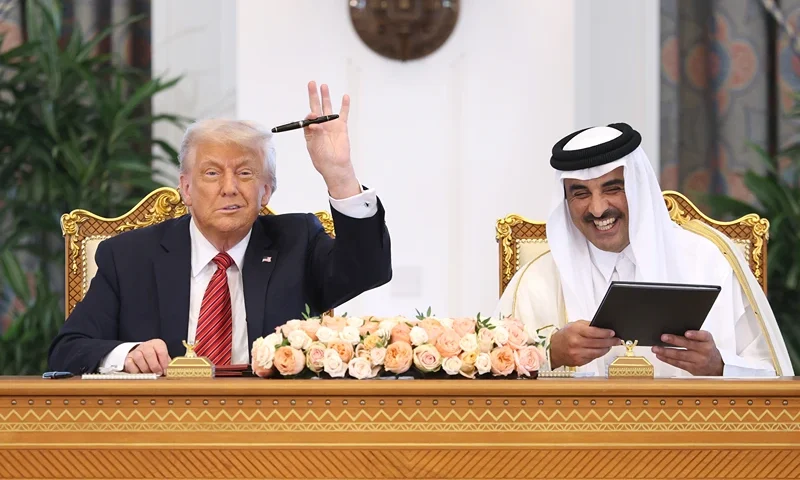 DOHA, QATAR - MAY 14: U.S. President Donald J. Trump and Emir of Qatar Tamim bin Hamad al Thani attend a signing ceremony at the Amiri Diwan, the official workplace of the emir, on May 14, 2025, in Doha, Qatar. The visit underscores the strategic partnership between the United States and Qatar, focusing on regional security and economic collaboration. (Photo by Win McNamee/Getty Images)