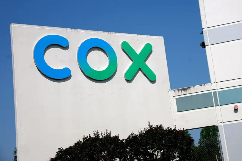 SPRINGFIELD, VIRGINIA - MAY 16: A Cox sign is seen on the Cox Communications Springfield Warehouse on May 16, 2025 in Springfield, Virginia. Cable Giants Charter and Cox agree to merge in $34.5 billion deal that, if approved, would create one of the largest TV and internet providers in the United States. (Photo by Kevin Dietsch/Getty Images)SPRINGFIELD, VIRGINIA - MAY 16: A Cox sign is seen on the Cox Communications Springfield Warehouse on May 16, 2025 in Springfield, Virginia. Cable Giants Charter and Cox agree to merge in $34.5 billion deal that, if approved, would create one of the largest TV and internet providers in the United States. (Photo by Kevin Dietsch/Getty Images)