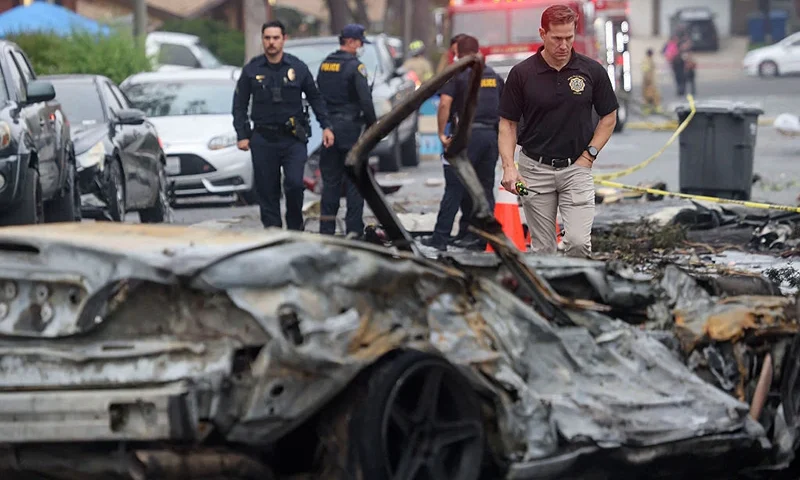 Investigators look through the site where a small plane crashed into a San Diego, California, residential street on May 22, 2025. The Federal Aviation Authority said a Cessna 550 crashed at around 3:45 am local time. The neighborhood is close to the Montgomery-Gibbs Executive Airport. The crash left a "gigantic debris field" and damaged some 15 homes and parked cars, ABC News quoted the San Diego assistant fire chief as saying. (Photo by Sandy Huffaker / AFP) (Photo by SANDY HUFFAKER/AFP via Getty Images)