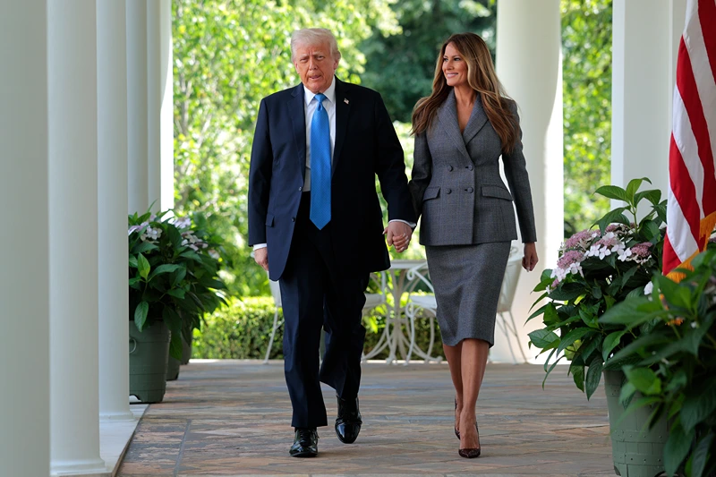 WASHINGTON, DC - MAY 19: U.S. President Donald Trump and first lady Melania Trump arrive at the signing ceremony for the TAKE IT DOWN Act in the Rose Garden of the White House on May 19, 2025 in Washington, DC. The first lady made the Tools to Address Known Exploitation by Immobilizing Technological Deepfakes on Websites and Networks (TAKE IT DOWN) Act a priority, traveling to Capitol Hill to lobby lawmakers and show her support for the legislation, which addresses non-consensual intimate imagery, or "revenge porn," and artificial intelligence deepfakes posted online and to social media. (Photo by Chip Somodevilla/Getty Images)
