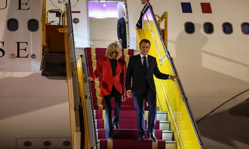 France's President Emmanuel Macron and his wife Brigitte Macron disembark from the plane upon their arrival at Noi Bai International Airport in Hanoi on May 25, 2025. French President Emmanuel Macron arrived in Hanoi on May 25, an AFP journalist saw, for the first leg of a Southeast Asia tour that will also see him travel to Indonesia and Singapore. (Photo by Ludovic MARIN / AFP) (Photo by LUDOVIC MARIN/AFP via Getty Images)
