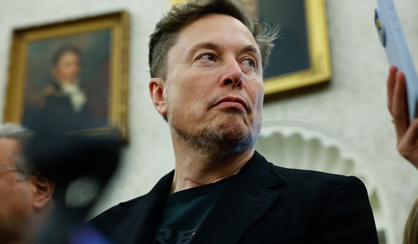 WASHINGTON, DC - MAY 21: Elon Musk listens as reporters ask U.S. President Donald Trump and South Africa President Cyril Ramaphosa questions during a press availability in the Oval Office at the White House on May 21, 2025 in Washington, DC. Relations between the two countries have been strained since Trump signed an executive order in February that claimed white South Africans are the victims of government land confiscation and race-based “genocide,” while admitting some of those Afrikaners as refugees to the United States. Trump also halted all foreign aid to South Africa and expelled the country’s Ambassador to the U.S., Ebrahim Rasool. (Photo by Chip Somodevilla/Getty Images)
