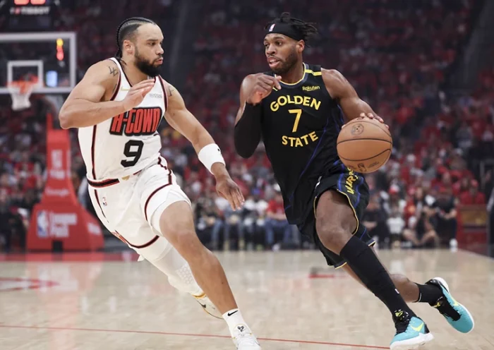 Golden State Warriors guard Buddy Hield (7) dribbles the ball as Houston Rockets forward Dillon Brooks (9) defends during the first quarter of game seven of the first round for the 2025 NBA Playoffs at Toyota Center. Mandatory Credit: Troy Taormina-Imagn Images