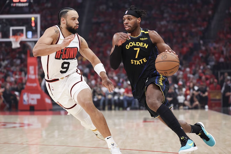 Golden State Warriors guard Buddy Hield (7) dribbles the ball as Houston Rockets forward Dillon Brooks (9) defends during the first quarter of game seven of the first round for the 2025 NBA Playoffs at Toyota Center. Mandatory Credit: Troy Taormina-Imagn Images