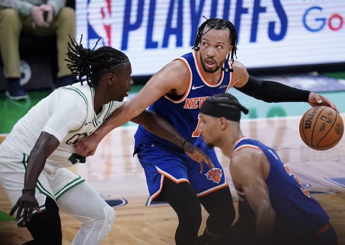 New York Knicks guard Jalen Brunson (11) moves the ball against Boston Celtics guard Jrue Holiday (4) in overtime during game one of the second round for the 2025 NBA Playoffs at TD Garden. Mandatory Credit: David Butler II-Imagn Image