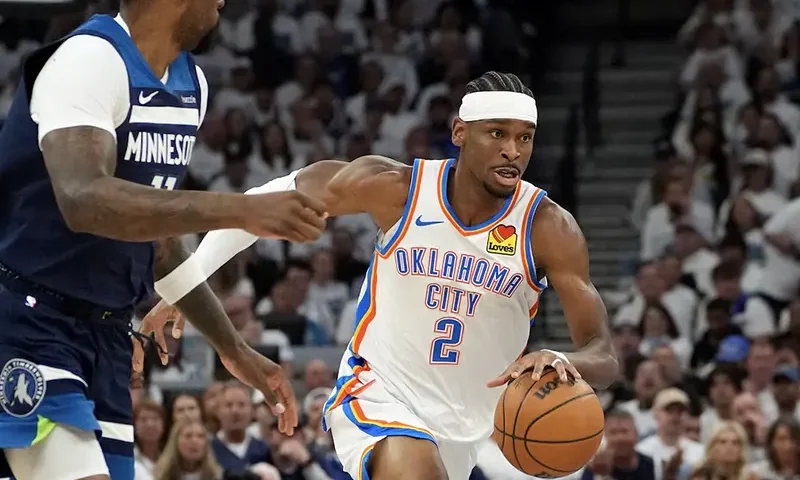 Oklahoma City Thunder guard Shai Gilgeous-Alexander (2) dribbles the ball past Minnesota Timberwolves center Naz Reid (11) in the first half during game four of the western conference finals for the 2025 NBA Playoffs at Target Center. Mandatory Credit: Bruce Kluckhohn-Imagn Images