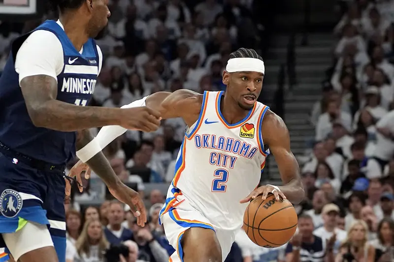 Oklahoma City Thunder guard Shai Gilgeous-Alexander (2) dribbles the ball past Minnesota Timberwolves center Naz Reid (11) in the first half during game four of the western conference finals for the 2025 NBA Playoffs at Target Center. Mandatory Credit: Bruce Kluckhohn-Imagn Images