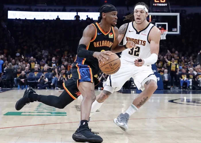 Oklahoma City Thunder guard Shai Gilgeous-Alexander (2) drives around Denver Nuggets forward Aaron Gordon (32) during the second half during game one of the second round for the 2025 NBA Playoffs at Paycom Center. Mandatory Credit: Alonzo Adams-Imagn Images