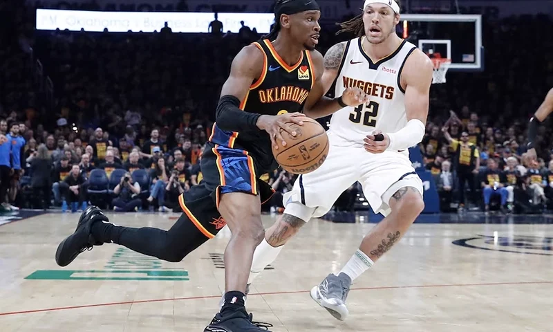 Oklahoma City Thunder guard Shai Gilgeous-Alexander (2) drives around Denver Nuggets forward Aaron Gordon (32) during the second half during game one of the second round for the 2025 NBA Playoffs at Paycom Center. Mandatory Credit: Alonzo Adams-Imagn Images
