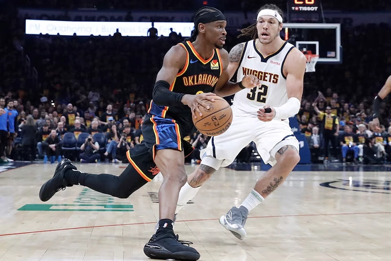 Oklahoma City Thunder guard Shai Gilgeous-Alexander (2) drives around Denver Nuggets forward Aaron Gordon (32) during the second half during game one of the second round for the 2025 NBA Playoffs at Paycom Center. Mandatory Credit: Alonzo Adams-Imagn Images