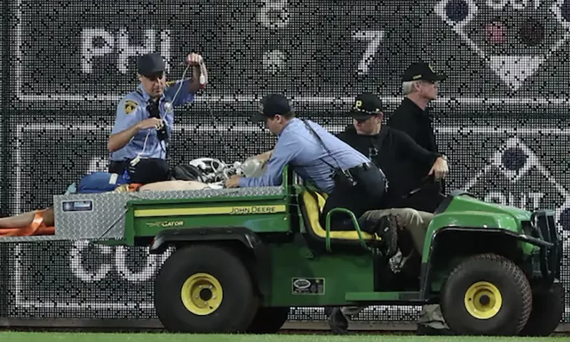 Stadium security and Pittsburgh Pirates medical personnel cart a fan who fell from the stands to the field to an ambulance as the Pirates batted against the Chicago Cubs during the seventh inningat PNC Park. Mandatory Credit: Charles LeClaire-Imagn Images