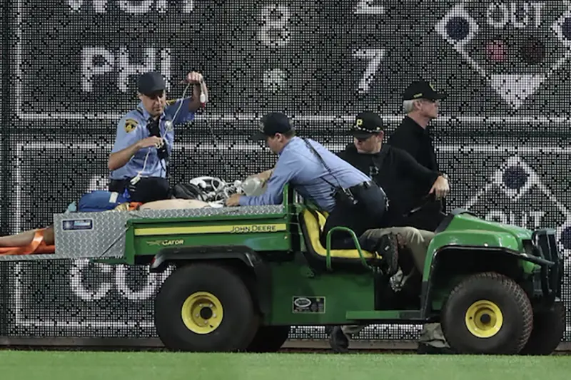 Stadium security and Pittsburgh Pirates medical personnel cart a fan who fell from the stands to the field to an ambulance as the Pirates batted against the Chicago Cubs during the seventh inningat PNC Park. Mandatory Credit: Charles LeClaire-Imagn Images
