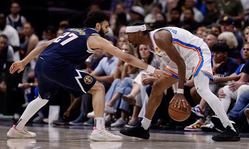 Oklahoma City Thunder guard Shai Gilgeous-Alexander (2) controls the ball as Denver Nuggets guard Jamal Murray (27) guards in the third quarter during game four of the second round of the 2025 NBA Playoffs at Ball Arena. Mandatory Credit: Isaiah J. Downing-Imagn Images