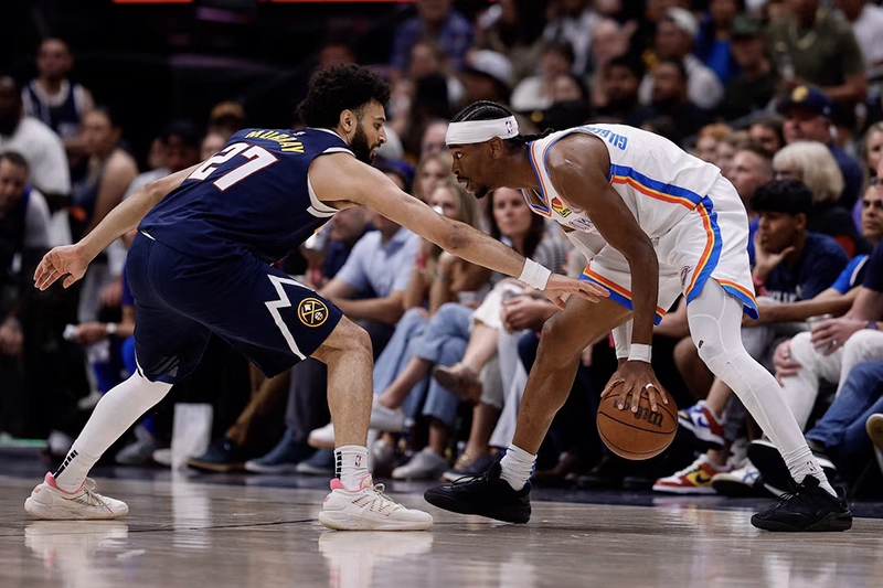 Oklahoma City Thunder guard Shai Gilgeous-Alexander (2) controls the ball as Denver Nuggets guard Jamal Murray (27) guards in the third quarter during game four of the second round of the 2025 NBA Playoffs at Ball Arena. Mandatory Credit: Isaiah J. Downing-Imagn Images